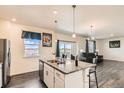 Modern kitchen featuring an island with bar seating, granite countertops, and stainless steel appliances at 2417 Mountain Sky Dr, Fort Lupton, CO 80621