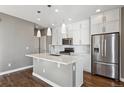 Modern kitchen featuring white cabinets and a large island at 10298 Tall Oaks Cir, Parker, CO 80134