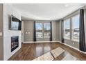 Spacious living room with hardwood floors and fireplace at 10298 Tall Oaks Cir, Parker, CO 80134