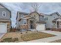 Two-story home featuring a stone accent entrance and a two-car garage at 15226 W 93Rd Ave, Arvada, CO 80007