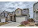 Charming two-story home with stone accents, attached garage, and landscaped front yard at 15226 W 93Rd Ave, Arvada, CO 80007
