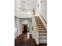 Bright foyer with hardwood floors, staircase, and natural light, offering a welcoming entrance to the home at 851 Racquet Ln, Boulder, CO 80303