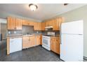 Bright kitchen features ample cabinet space, white appliances, stylish backsplash and durable tile flooring at 5721 W 92Nd Ave # 96, Westminster, CO 80031