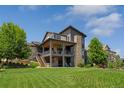 Expansive backyard with a covered deck and patio, perfect for outdoor living and entertaining at 10826 Evergold Way, Highlands Ranch, CO 80126