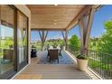 Inviting covered deck with outdoor dining area, offering scenic views of the surrounding landscape at 10826 Evergold Way, Highlands Ranch, CO 80126