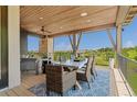 Charming covered deck featuring an outdoor dining area, perfect for enjoying meals with a view at 10826 Evergold Way, Highlands Ranch, CO 80126