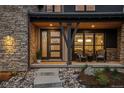 Inviting front porch with stone accents, stylish seating, and a welcoming entrance at 10826 Evergold Way, Highlands Ranch, CO 80126