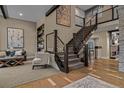 Elegant staircase with metal railings and an open design, leading to the upper level at 10826 Evergold Way, Highlands Ranch, CO 80126