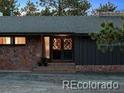 Close up of home entry with decorative doors and stone accents at 21859 Grandview Ave, Golden, CO 80401