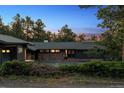 Charming ranch-style home featuring stone accents, mature trees, and a private setting at 21859 Grandview Ave, Golden, CO 80401