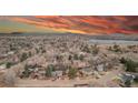 Expansive aerial view showcasing the neighborhood, mature trees, and a nearby lake at 901 Delphi Dr, Lafayette, CO 80026