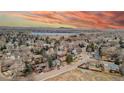 Serene aerial view of a residential area with a lake and mountain views in the background at 901 Delphi Dr, Lafayette, CO 80026