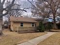 View of the side exterior showcasing well-maintained landscaping and a fenced yard at 2045 S Monroe St, Denver, CO 80210