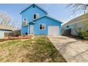 Inviting two-story blue home featuring well-maintained lawn and convenient driveway leading to the garage at 4922 S Rifle Ct, Aurora, CO 80015