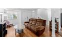 Inviting living room with hardwood floors, a plush sofa, and bright, airy ambiance at 4922 S Rifle Ct, Aurora, CO 80015