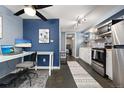 Combined kitchen and office space, featuring a desk setup and modern appliances in a compact layout at 1310 N Corona St # A, Denver, CO 80218