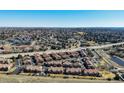 Wide aerial view of a neighborhood showcasing well-maintained homes, landscaping, and access to a nearby highway at 4648 S Abilene Cir, Aurora, CO 80015