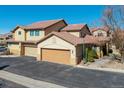 Attractive townhome featuring a tiled roof, attached garages, and well-maintained landscaping in a community setting at 4648 S Abilene Cir, Aurora, CO 80015