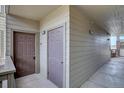 Exterior hallway with two unit entrances, painted siding and wall mounted lights at 12914 Ironstone Way # 201, Parker, CO 80134