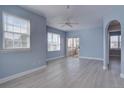Open living room with light blue walls, white trim and ceiling fan at 12914 Ironstone Way # 201, Parker, CO 80134