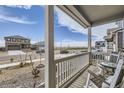 Inviting front porch with seating, offering a pleasant view of the street and surrounding neighborhood at 27425 E Byers Pl, Aurora, CO 80018