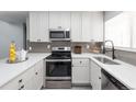 Modern kitchen featuring white cabinets, quartz countertops, and stainless steel appliances at 14396 E Florida Ave # B, Aurora, CO 80012