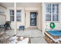 Front porch of the townhome with chairs and a small table at 2054 S Xenia Way # 59, Denver, CO 80231