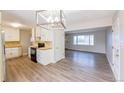 Bright kitchen features white cabinets, modern appliances, and laminate flooring at 234 Lansing St, Aurora, CO 80010