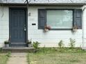 Charming home exterior features a blue door, flower boxes, and a well-maintained lawn at 1388 Kenton, Aurora, CO 80010