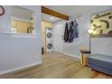 Inviting entryway features hardwood floors, stacked washer/dryer, coat rack, and stylish decor at 2636 Juniper Ave # 39-1, Boulder, CO 80304