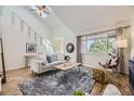 Bright, open living room features high ceilings, skylight, modern furnishings and neutral color palette at 1073 W Powers Ave, Littleton, CO 80120