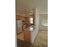 Functional kitchen featuring wood cabinets and essential appliances at 2793 Roslyn St, Denver, CO 80238