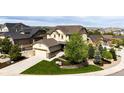 Tan two-story home with a two car garage and a well manicured lawn at 2115 Holmby Ct, Castle Rock, CO 80104