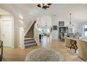 Grand foyer with a staircase leading to a living area with an open floor plan at 74 Blue Heron Dr, Greenwood Village, CO 80121