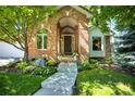 Beautiful brick home with a lush front yard and inviting entrance at 74 Blue Heron Dr, Greenwood Village, CO 80121