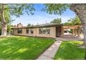 Beautifully landscaped home with a spacious yard and a covered patio area at 1637 S Stuart St, Denver, CO 80219