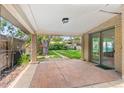 Covered patio with brick flooring and a view of the well-maintained backyard at 1637 S Stuart St, Denver, CO 80219
