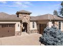 Beautiful stone accents highlight this charming home, complemented by a well-manicured lawn at 6449 E 163Rd Ave, Brighton, CO 80602