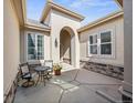 Charming patio with seating, stone accents, and an inviting entrance to the house at 6449 E 163Rd Ave, Brighton, CO 80602