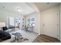 Cozy living space with large window, sliding glass door, and comfortable seating arrangement at 13625 E 103Rd Pl, Commerce City, CO 80022
