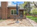 Inviting brick patio with seating, creating a cozy outdoor space to relax outside this beautiful brick home at 1900 Magnolia St, Denver, CO 80220