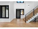 Bright entryway with hardwood floors and modern staircase at 8077 Raphael Ln, Littleton, CO 80125