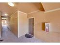 Well-lit condo hallway with neutral walls, unit door, and fire extinguisher at 17497 Nature Walk Trl # 302, Parker, CO 80134