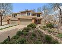 Charming home with well-manicured landscaping, a two-car garage, and inviting curb appeal at 1571 S Trenton Ct, Denver, CO 80231