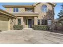 Front view of a two-story brick home with a landscaped yard at 2457 S Xenon Way, Denver, CO 80228