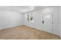 Bright living room featuring hardwood floors, ample natural light, and fresh white paint at 17123 W 91St Ln, Arvada, CO 80007