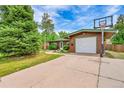 Exterior view of home featuring an attached garage with a basketball hoop and well-kept front yard at 5722 W Chestnut Ave, Littleton, CO 80128