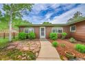 Charming single-story house showcasing a well-maintained exterior with lush landscaping and a welcoming entrance at 5722 W Chestnut Ave, Littleton, CO 80128