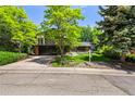 Inviting two-story home with lush landscaping, a brick facade, and a well-manicured lawn at 7234 S Kendall Ct, Littleton, CO 80128