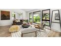 Stylish living room with modern decor, large windows, and ample natural light at 7234 S Kendall Ct, Littleton, CO 80128